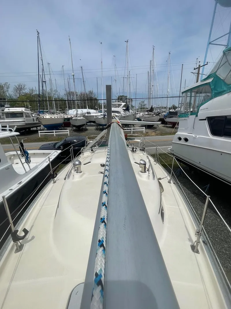 Slide: The Image of 2005 Hake Seaward 32RK sailboat docked among other vessels in a marina. - 13