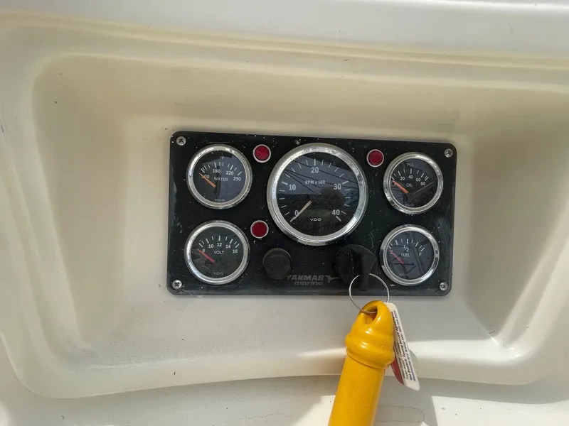 Slide: The Image of Instrument panel of a 2005 Hake Seaward 32RK boat with gauges and key. - 15