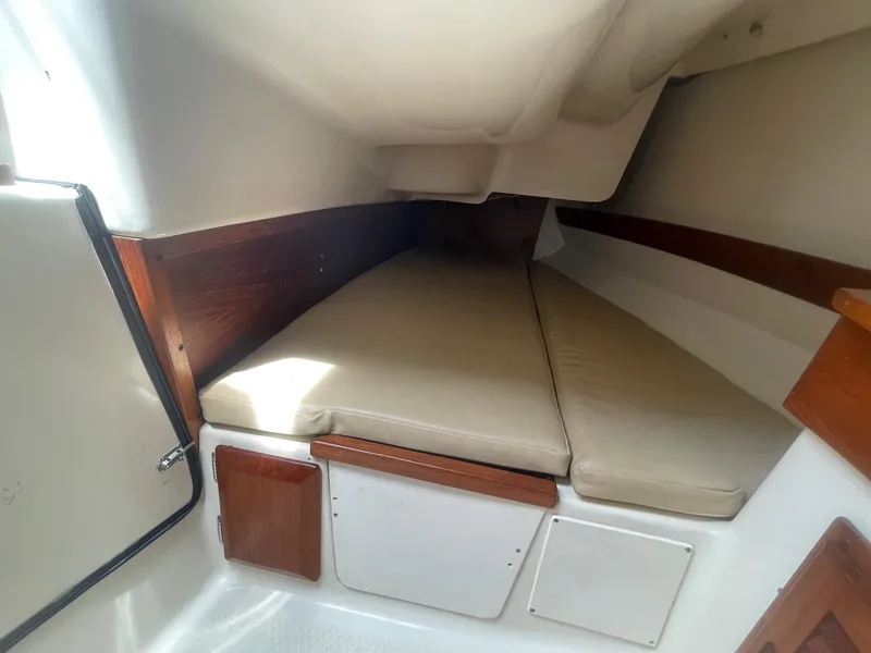 Slide: The Image of 2005 Hake Seaward 32RK cabin interior with cushioned berth and wooden accents. - 18