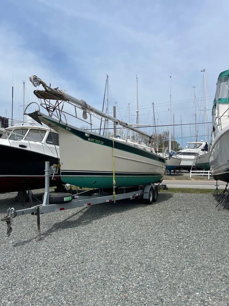 Slide: The Image of 2005 Hake Seaward 32RK sailboat on trailer in marina, surrounded by other boats. - 26