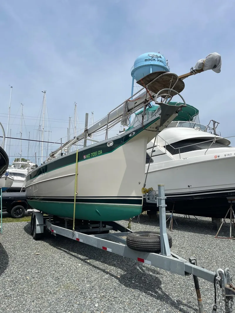 Slide: The Image of 2005 Hake Seaward 32RK sailboat on trailer in marina, surrounded by other boats. - 27