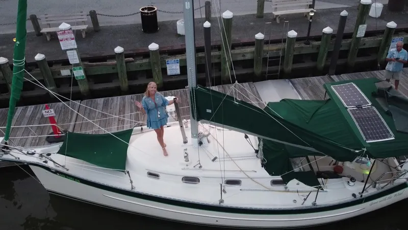 Slide: The Image of 2005 Hake Seaward 32RK sailboat docked with green covers and solar panels. - 30