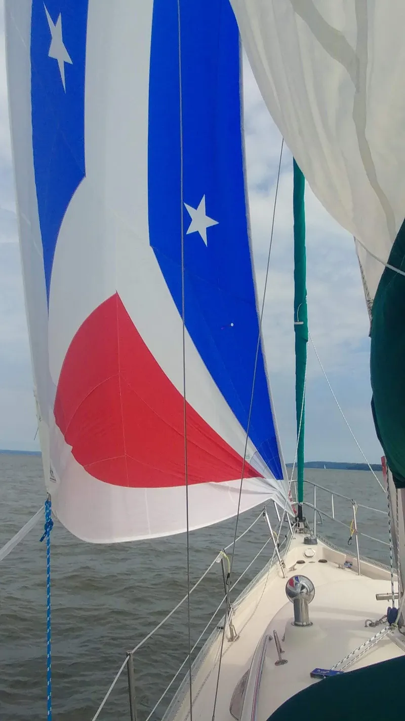 Slide: The Image of Sailing on a 2005 Hake Seaward 32RK with colorful sails on a calm sea. - 5