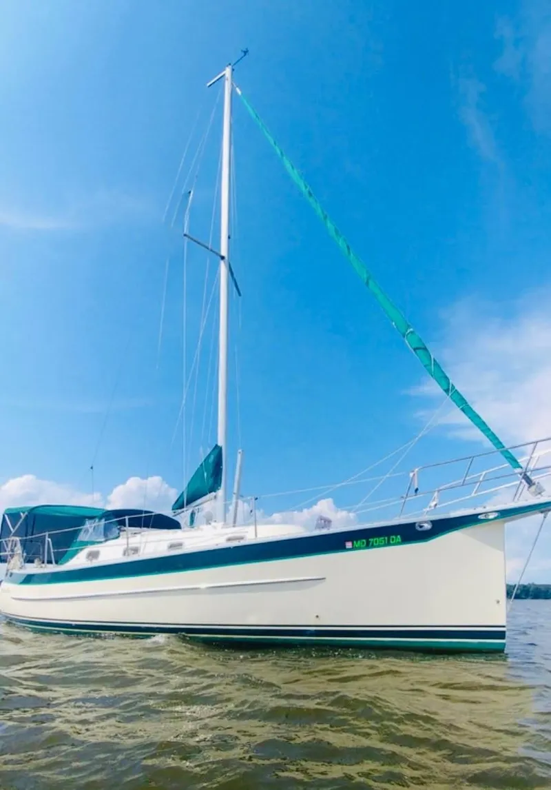 Slide: The Image of 2005 Hake Seaward 32RK sailboat on calm water under clear blue sky. - 6