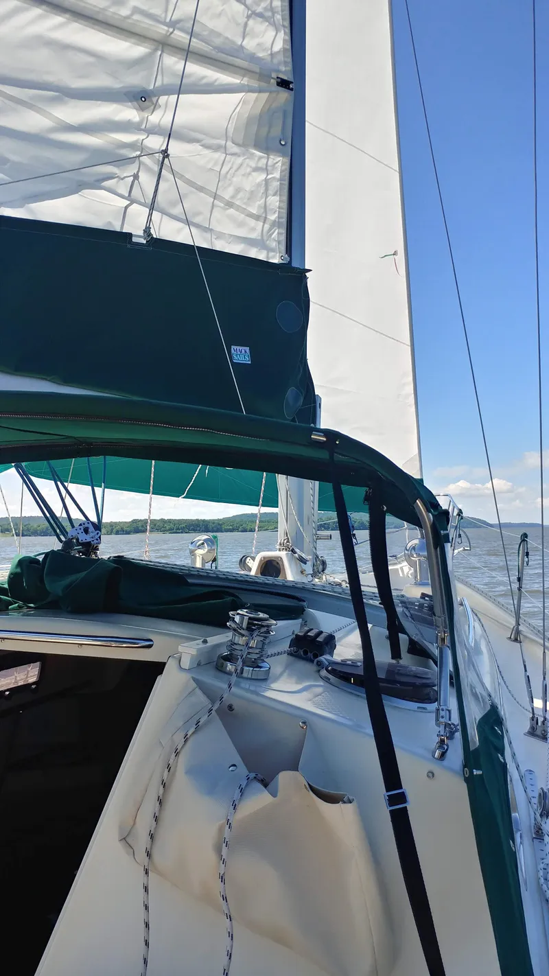 Slide: The Image of Sailing on a 2005 Hake Seaward 32RK with sails unfurled under a clear blue sky. - 7