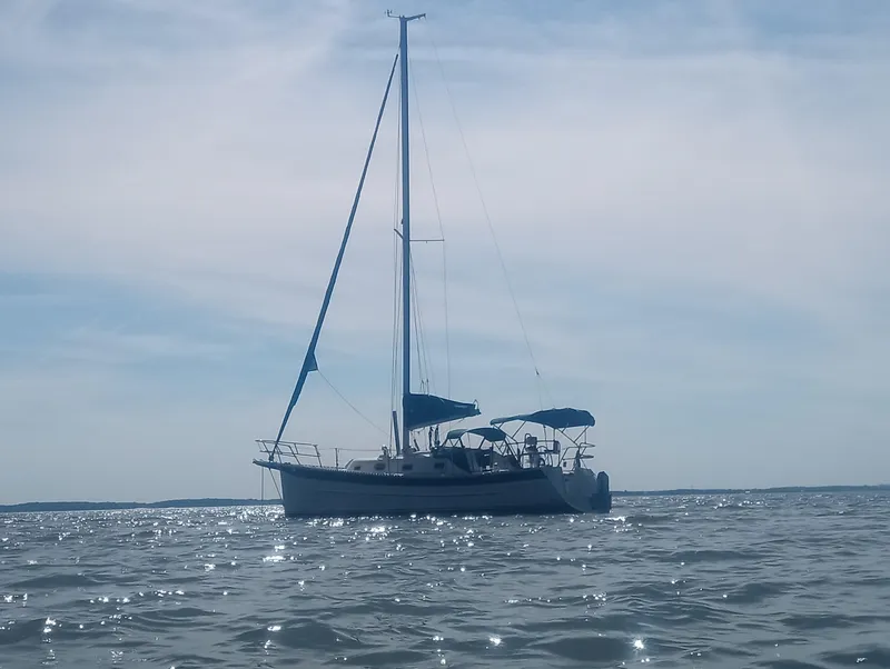 Slide: The Image of 2005 Hake Seaward 32RK sailboat on calm waters under a clear sky. - 9