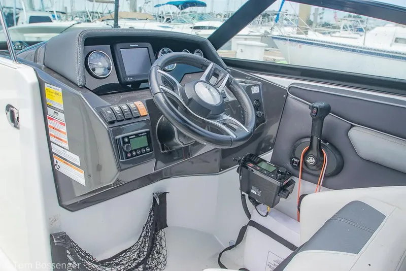 Slide: The Image of Cockpit of 2018 Monterey MX6 Surf Edition boat with steering wheel and control panel. - 11