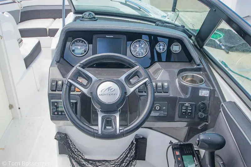 Slide: The Image of 2018 Monterey MX6 Surf Edition boat dashboard with steering wheel and control panel. - 12