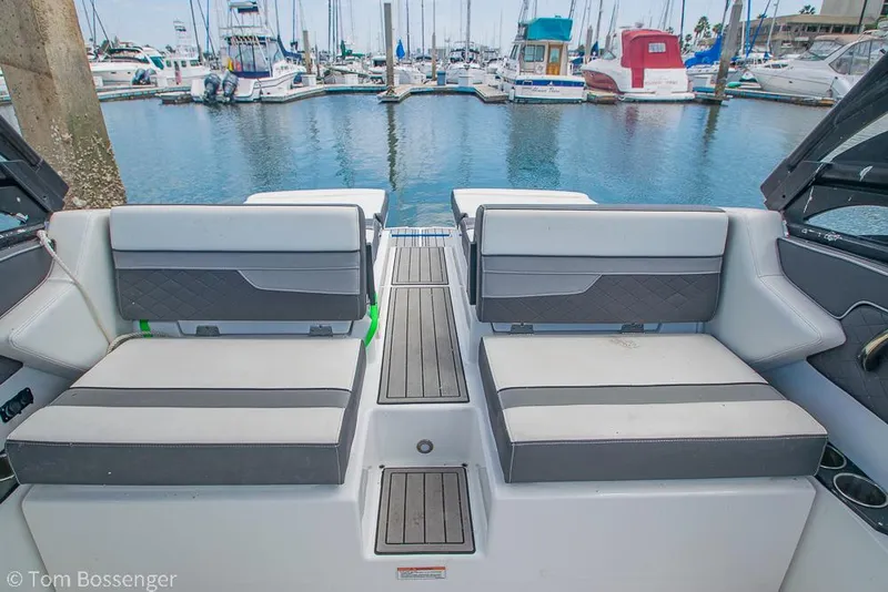 Slide: The Image of 2018 Monterey MX6 Surf Edition boat interior with marina view. - 18