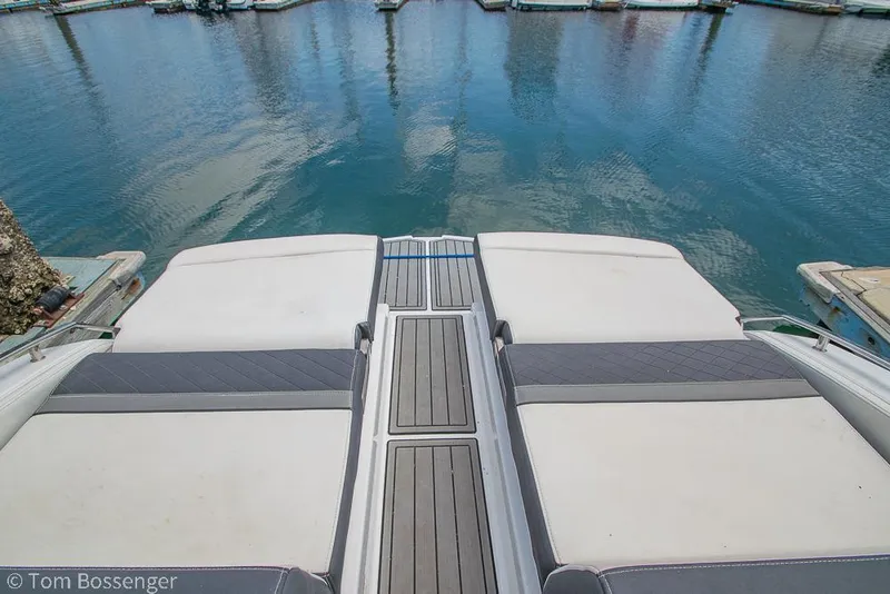 Slide: The Image of 2018 Monterey MX6 Surf Edition boat deck overlooking calm marina waters. - 19