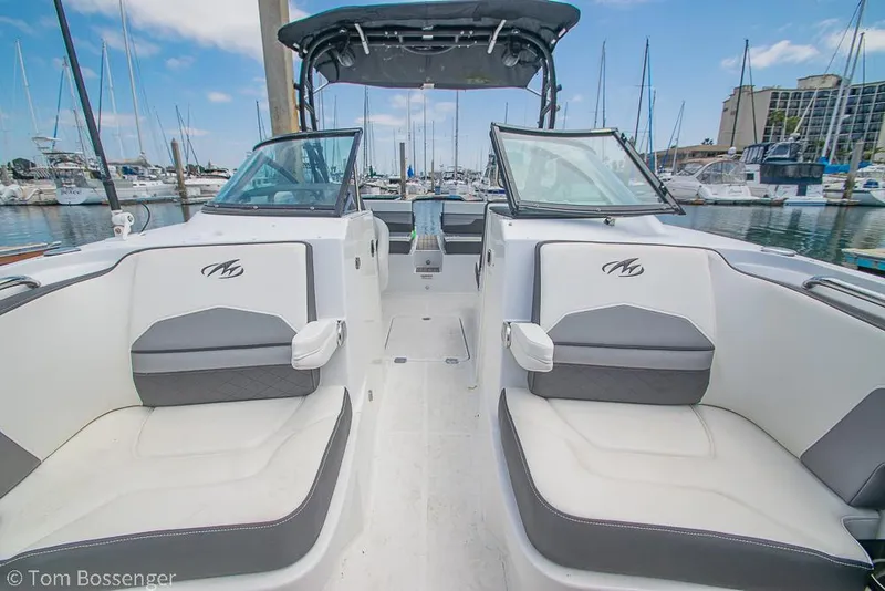 Slide: The Image of 2018 Monterey MX6 Surf Edition boat interior at marina, featuring sleek seating and modern design. - 23