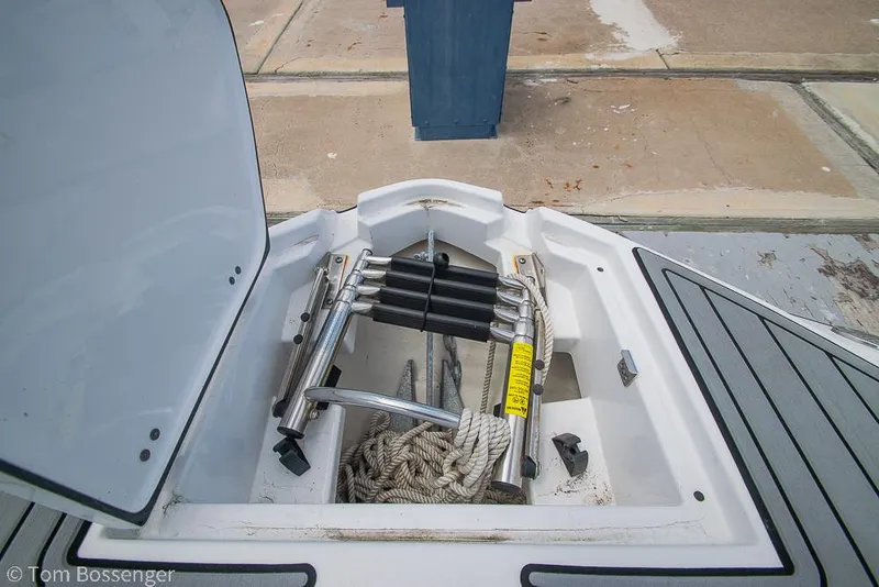 Slide: The Image of Open storage compartment on 2018 Monterey MX6 Surf Edition boat with ladder and ropes. - 24