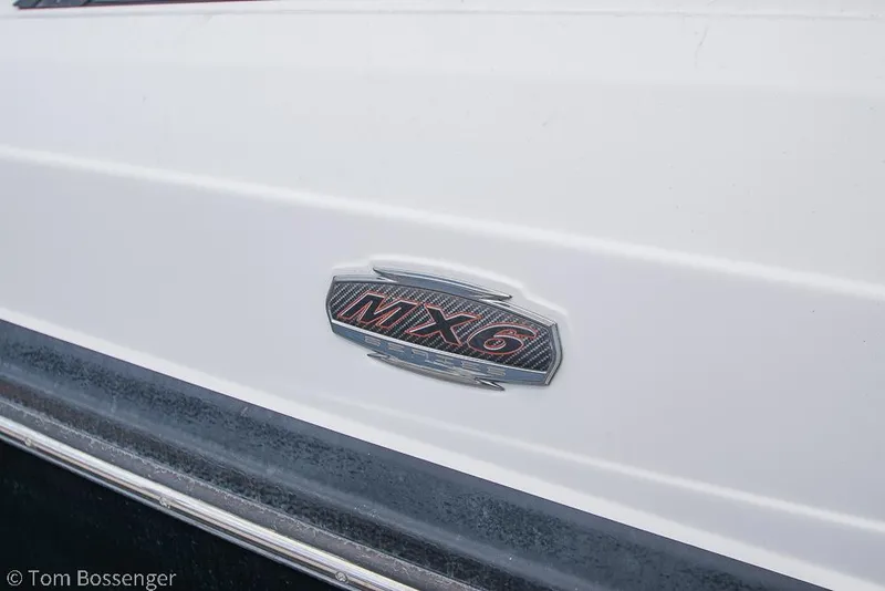 Slide: The Image of 2018 Monterey MX6 Surf Edition boat emblem on white surface. - 6