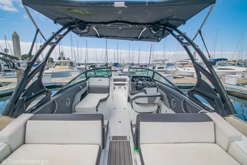 Slide: The Image of 2018 Monterey MX6 Surf Edition boat interior at marina, featuring sleek seating and modern design. - 8