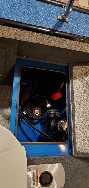 Slide: The Image of 2023 Polar Kraft Kodiak Sport 185 FS boat storage compartment with visible wiring and equipment. - 16