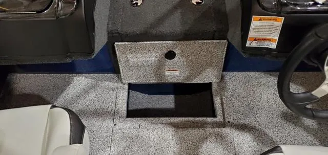 Slide: The Image of 2023 Polar Kraft Kodiak Sport 185 FS boat interior with storage compartment and steering wheel. - 19