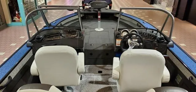 Slide: The Image of 2023 Polar Kraft Kodiak Sport 185 FS boat interior with dual white seats and control panel. - 5