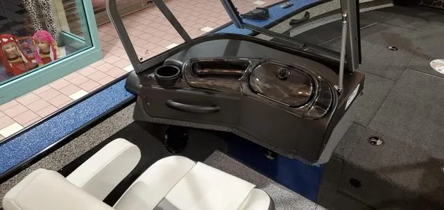 Slide: The Image of 2023 Polar Kraft Kodiak Sport 185 FS boat interior with seating and console. - 9