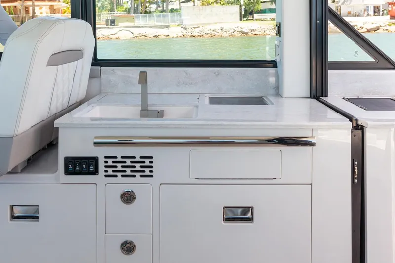 Slide: The Image of 2026 Regal 36 Grande Coupe helm with dual displays and modern controls in a showroom. - 15