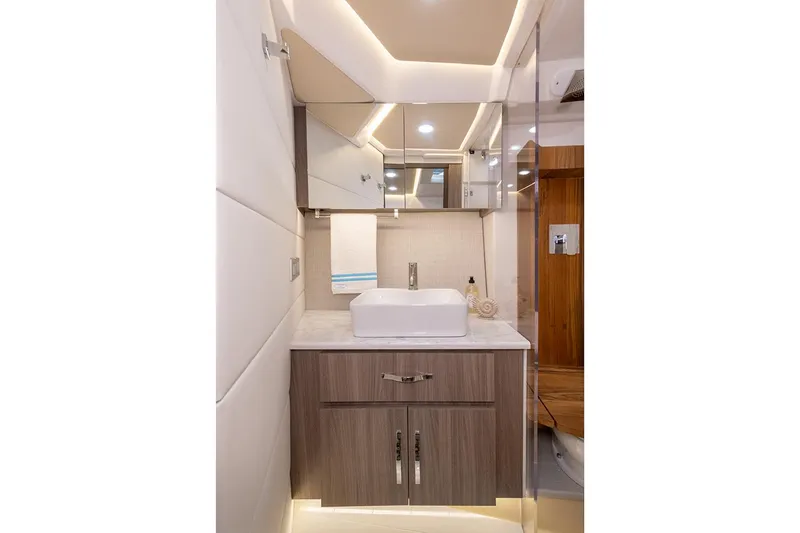 Slide: The Image of Interior of 2026 Regal 36 Grande Coupe with white seating and wooden accents. - 25