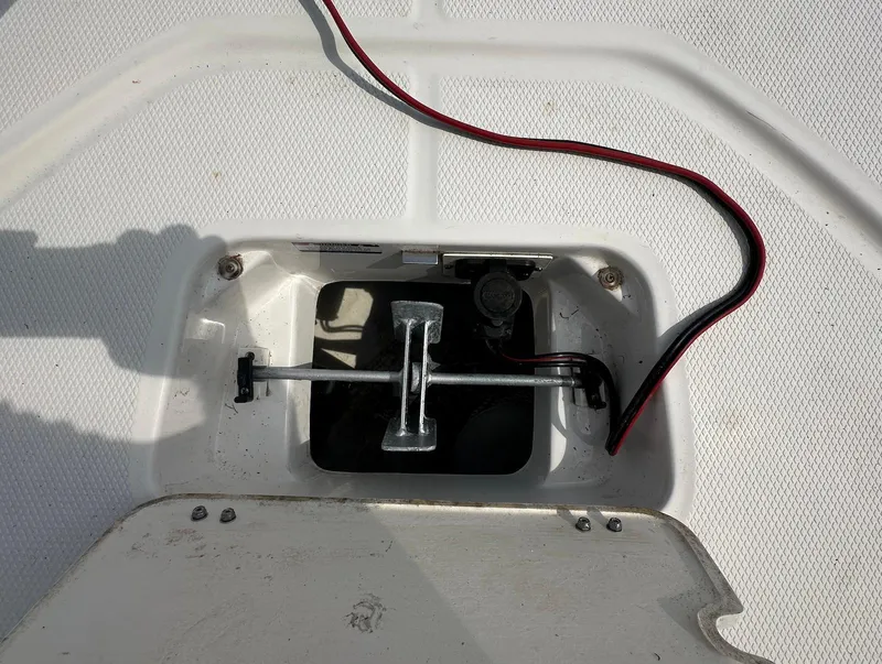 Slide: The Image of 2023 Robalo 226 Cayman boat compartment with wiring and metal components visible. - 11