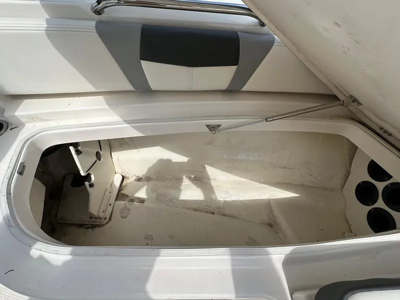 Slide: The Image of Open storage compartment in 2023 Robalo 226 Cayman boat interior. - 12