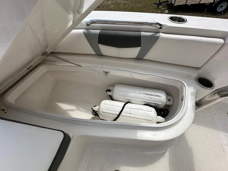 Slide: The Image of 2023 Robalo 226 Cayman boat storage compartment with fenders inside. - 13