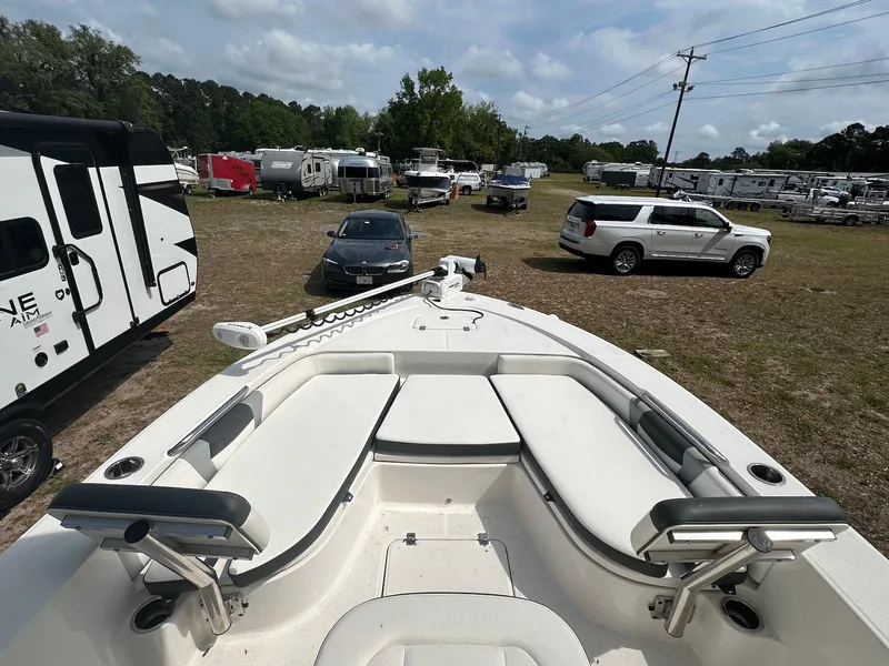 Slide: The Image of 2023 Robalo 226 Cayman boat in a lot with cars and RVs. - 4