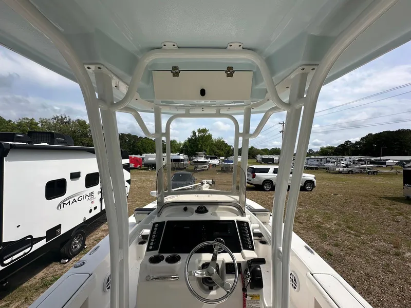 Slide: The Image of 2023 Robalo 226 Cayman boat interior with steering wheel and control panel. - 6