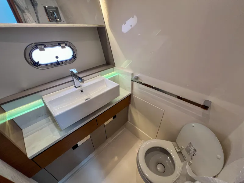 Slide: The Image of 2023 Tiara Yachts 38 LS bathroom with modern sink and toilet. - 11