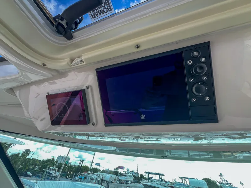 Slide: The Image of Control panel of 2023 Tiara Yachts 38 LS with digital displays and buttons. - 18
