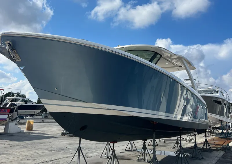Slide: The Image of 2023 Tiara Yachts 38 LS boat on stands under a blue sky. - 2