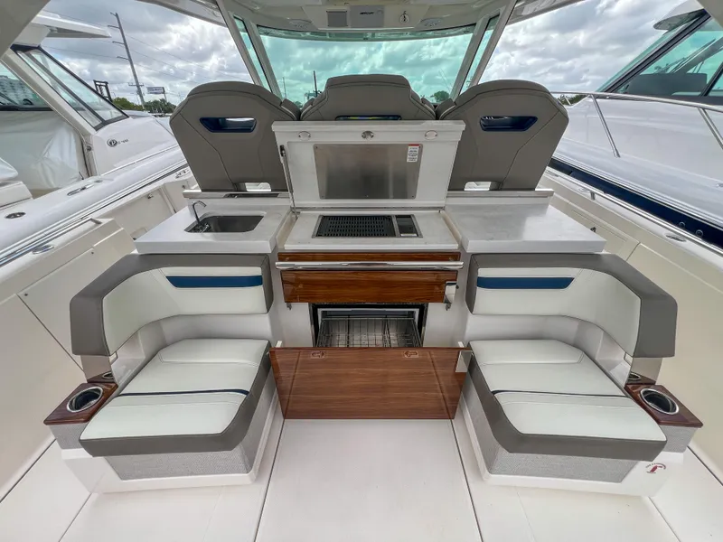 Slide: The Image of 2023 Tiara Yachts 38 LS interior with seating and kitchenette, featuring modern design elements. - 21