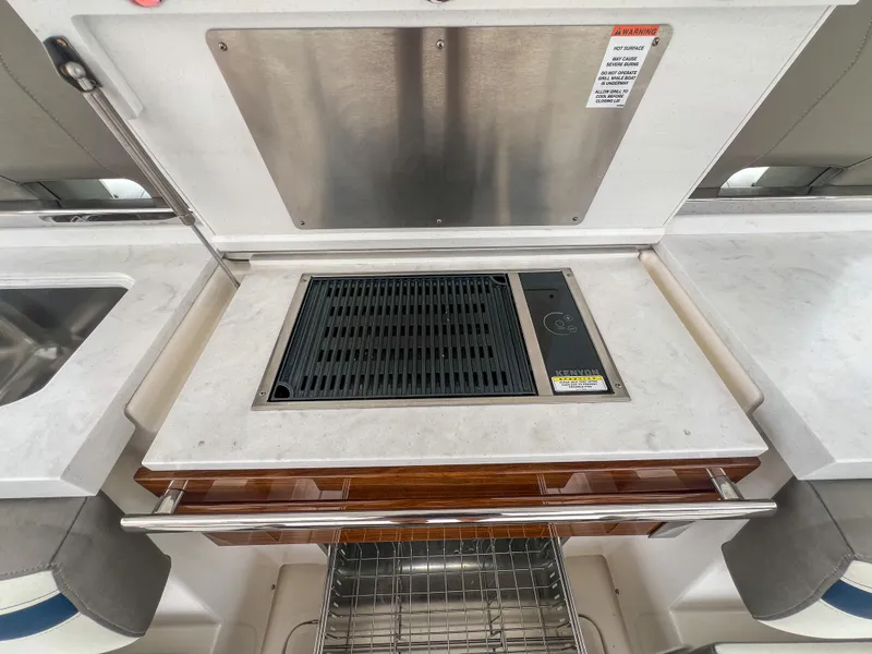 Slide: The Image of 2023 Tiara Yachts 38 LS yacht grill and sink area with modern design. - 22
