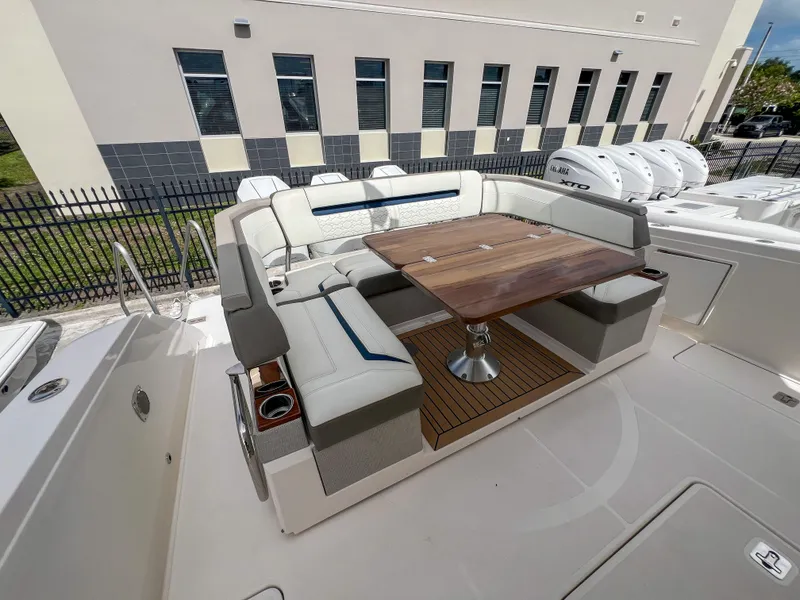 Slide: The Image of 2023 Tiara Yachts 38 LS with elegant seating and wooden table on deck. - 25