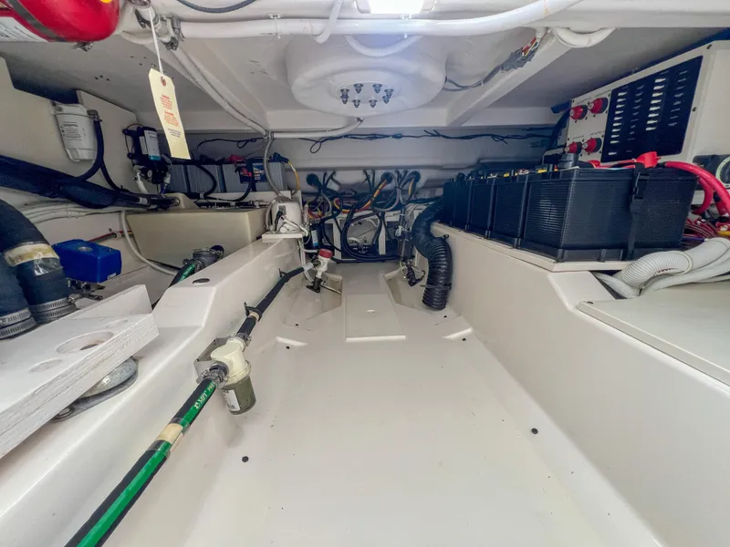 Slide: The Image of Engine room of 2023 Tiara Yachts 38 LS, showcasing wiring and battery systems. - 28