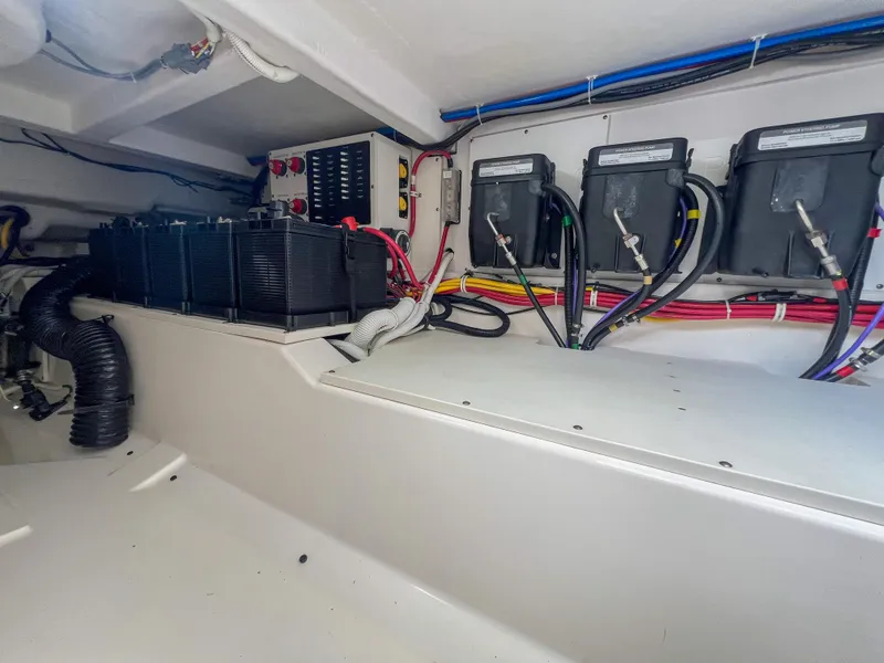 Slide: The Image of 2023 Tiara Yachts 38 LS engine compartment with batteries and wiring. - 29