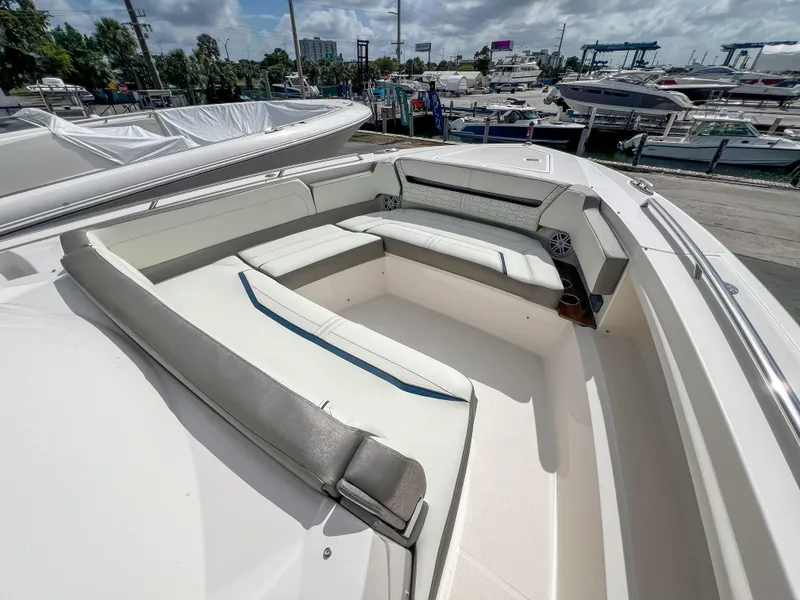 Slide: The Image of 2023 Tiara Yachts 38 LS boat with spacious seating at a marina. - 3