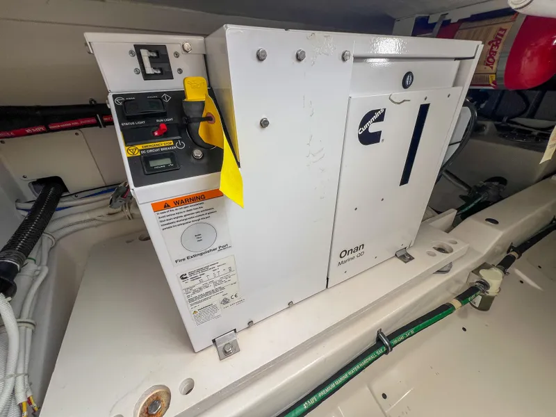 Slide: The Image of 2023 Tiara Yachts 38 LS engine compartment featuring an Onan generator. - 30