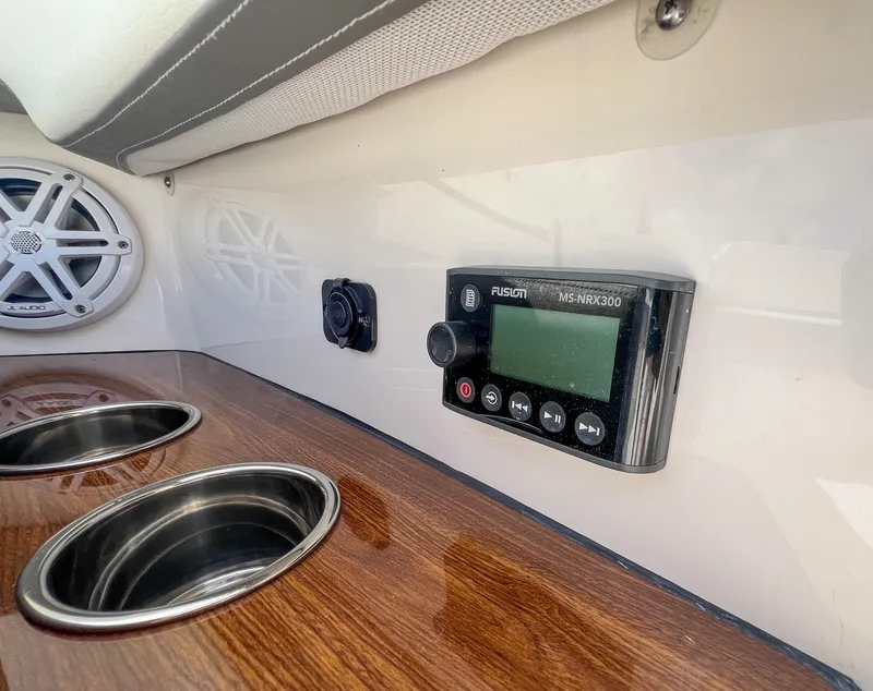 Slide: The Image of 2023 Tiara Yachts 38 LS interior with Fusion stereo and cup holders. - 4