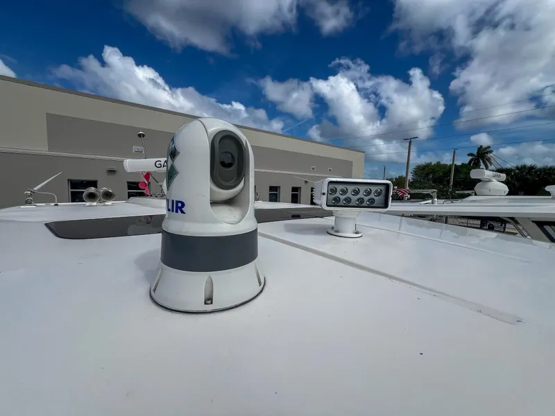 Slide: The Image of 2023 Tiara Yachts 38 LS with advanced navigation equipment under a partly cloudy sky. - 9