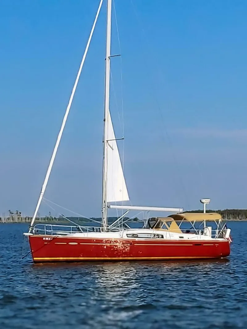Slide: The Image of 2008 Beneteau Oceanis 43 sailboat with red hull on calm water. - 1