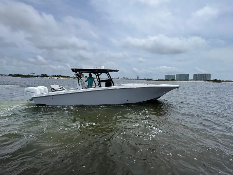 The Image of 2022 Fountain 38TE boat cruising on a cloudy day in open water. - 1