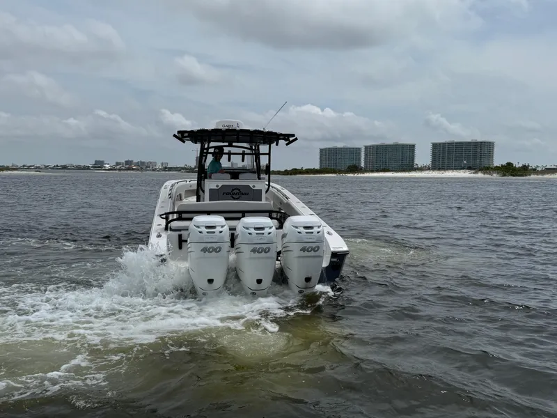 Slide: The Image of 2022 Fountain 38TE boat with triple 400 engines cruising on water. - 13