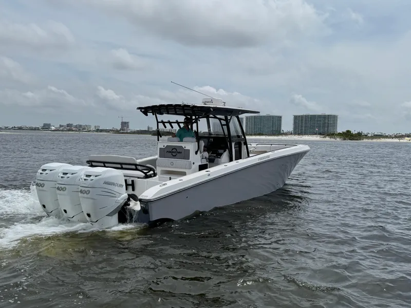 Slide: The Image of 2022 Fountain 38TE boat cruising on water with triple 400 horsepower engines. - 17