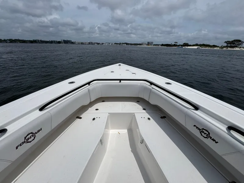 Slide: The Image of 2022 Fountain 38TE boat on open water, showcasing spacious deck and seating. - 20