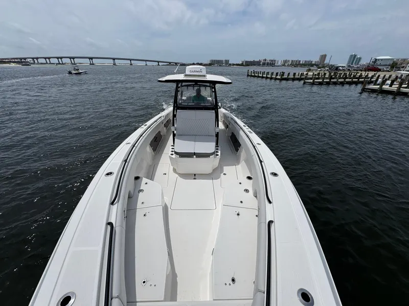 Slide: The Image of 2022 Fountain 38TE boat on water, bridge and cityscape in background. - 22
