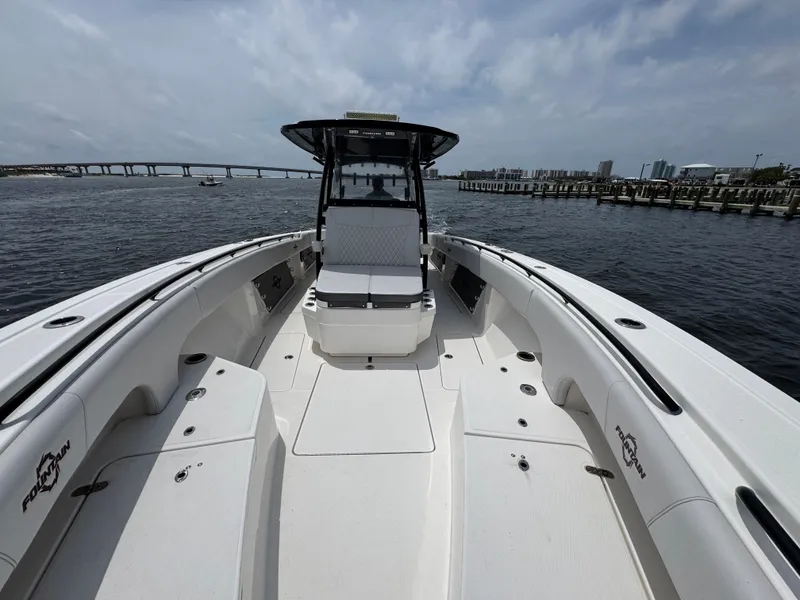 Slide: The Image of 2022 Fountain 38TE boat on water with bridge and city skyline in background. - 23