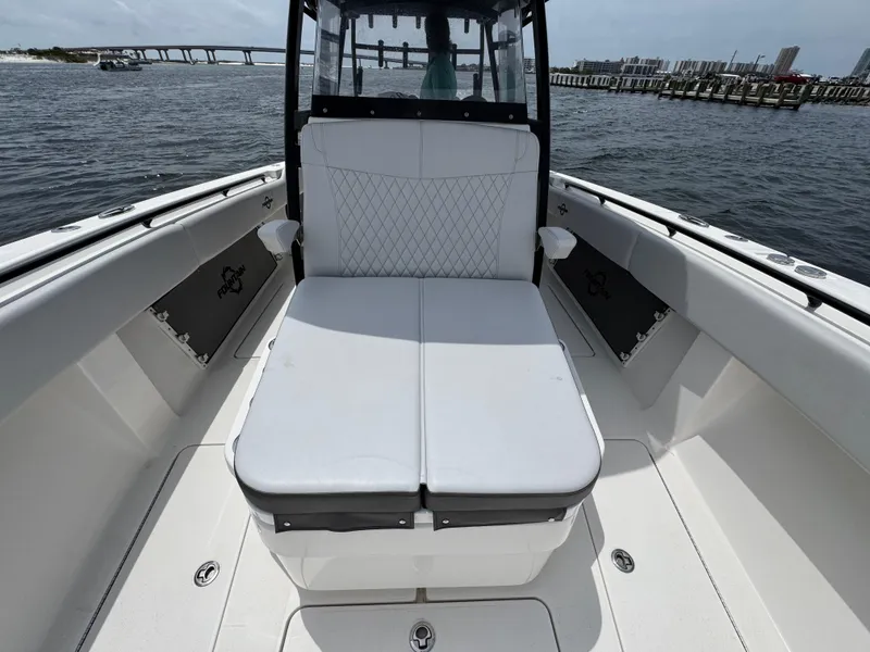 Slide: The Image of 2022 Fountain 38TE boat with white seating, docked near a bridge and waterfront. - 24