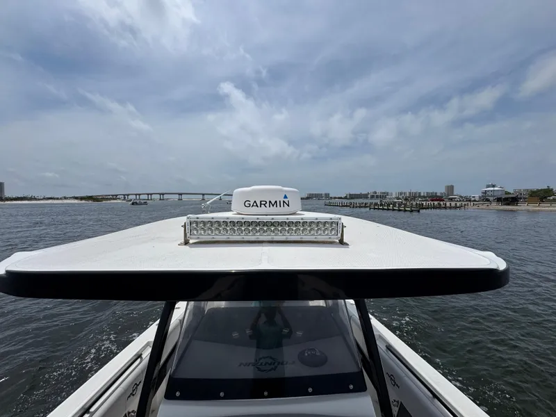 Slide: The Image of 2022 Fountain 38TE boat with Garmin equipment on open water, under a cloudy sky. - 25